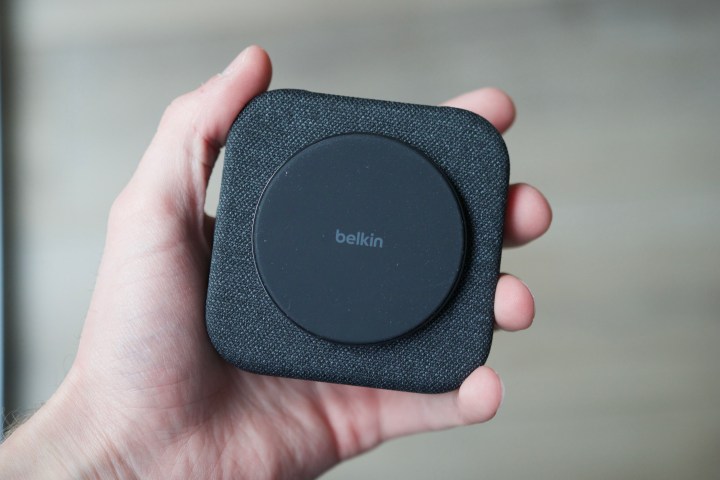 Someone holding Belkin's charging pad, folded up.