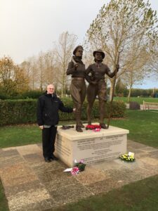 Stuart Antrobus next to the memorial to the WLA and WTC following its unveiling in October 2014 at the National Memorial Aboretum.