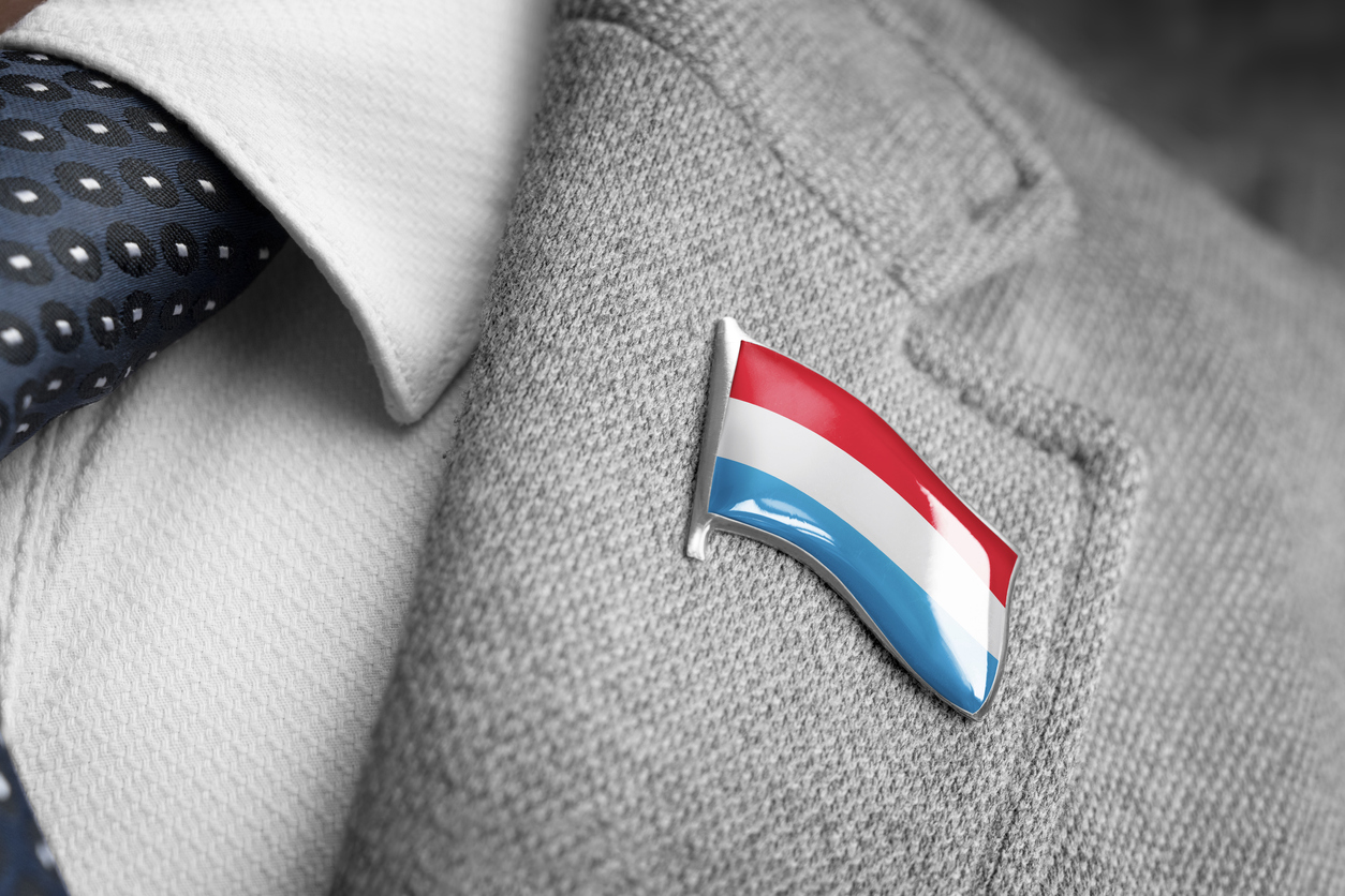 Metal badge with the flag of Luxembourg on a suit lapel