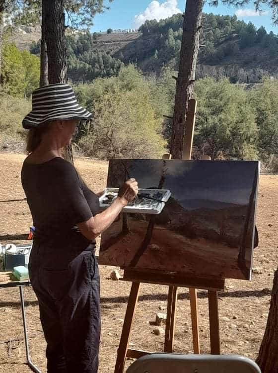 The artist, Francesca Wyllie painting at the Embalse de Iznajar, Andalucia