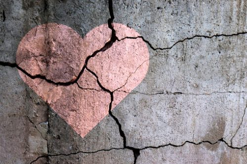 Lyserødt hjerte malet på betonmur som er knust