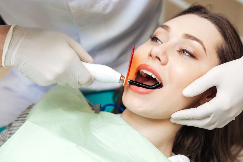 Close-up portrait of a girl getting her teeth bleached