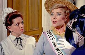 An image of Mrs Banks from Mary Poppins in a pink, white and blue suffragette banner. 