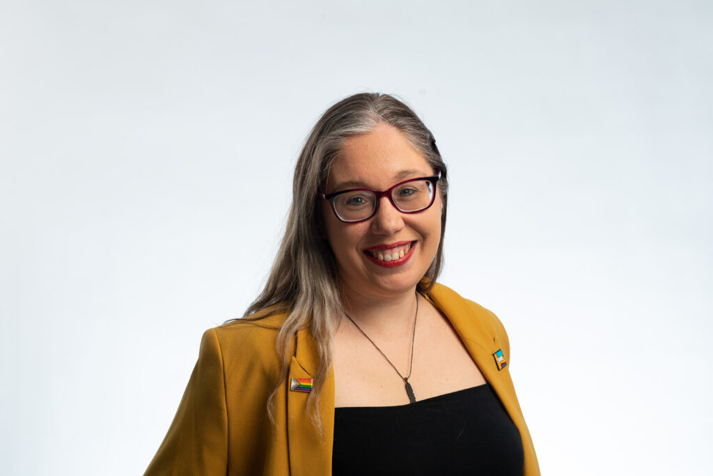 A woman, smiling at the camera. 