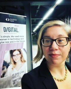 A selfie in front of the DigitalHer Sign.