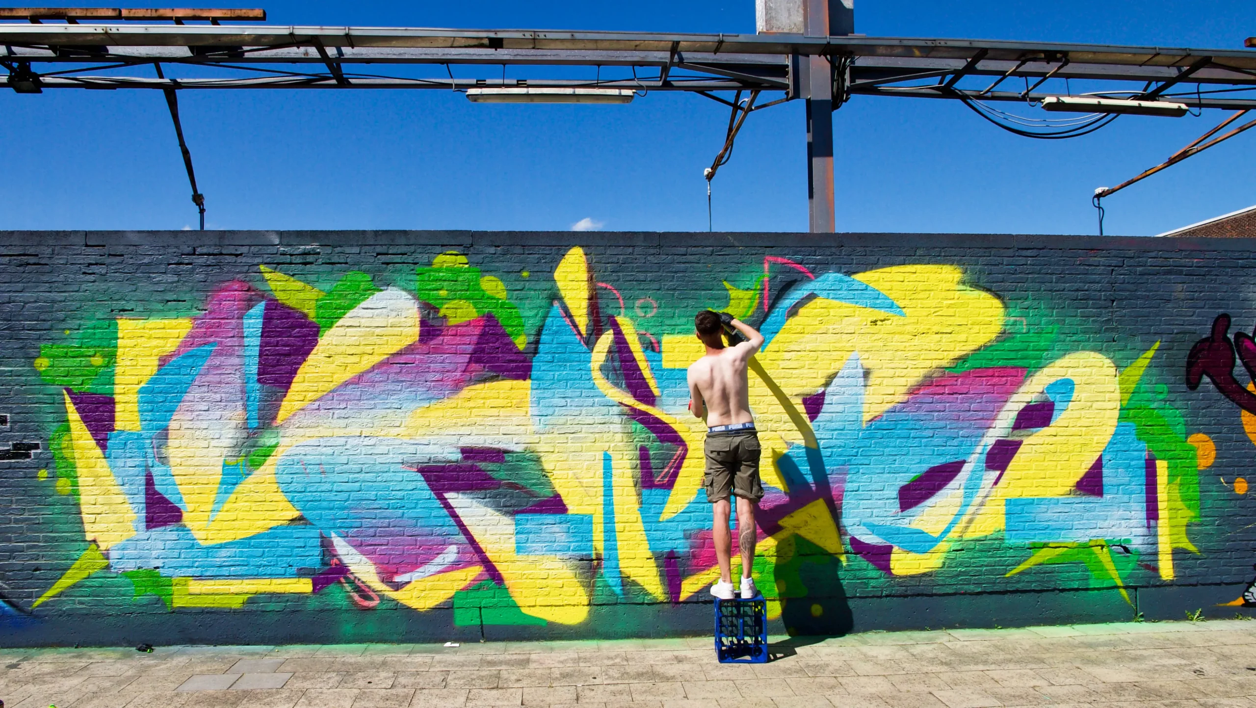 Artist painting on a wall.